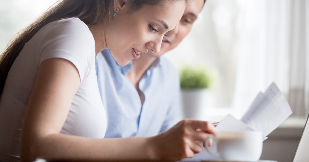 Parent reviewing OPWDD eligibility requirements documents for a child