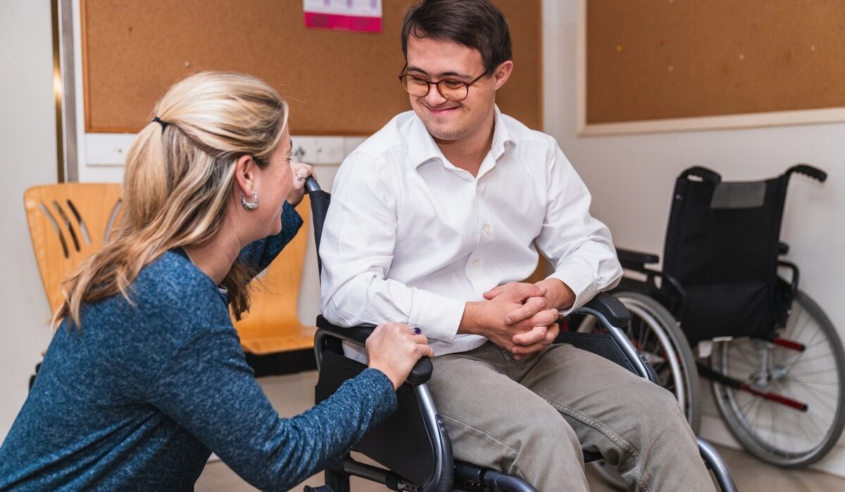 Young man in wheelchair meeting with a care professional for an OPWDD CAS assessment