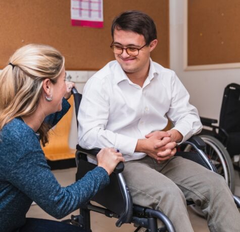 Young man in wheelchair meeting with a care professional for an OPWDD CAS assessment