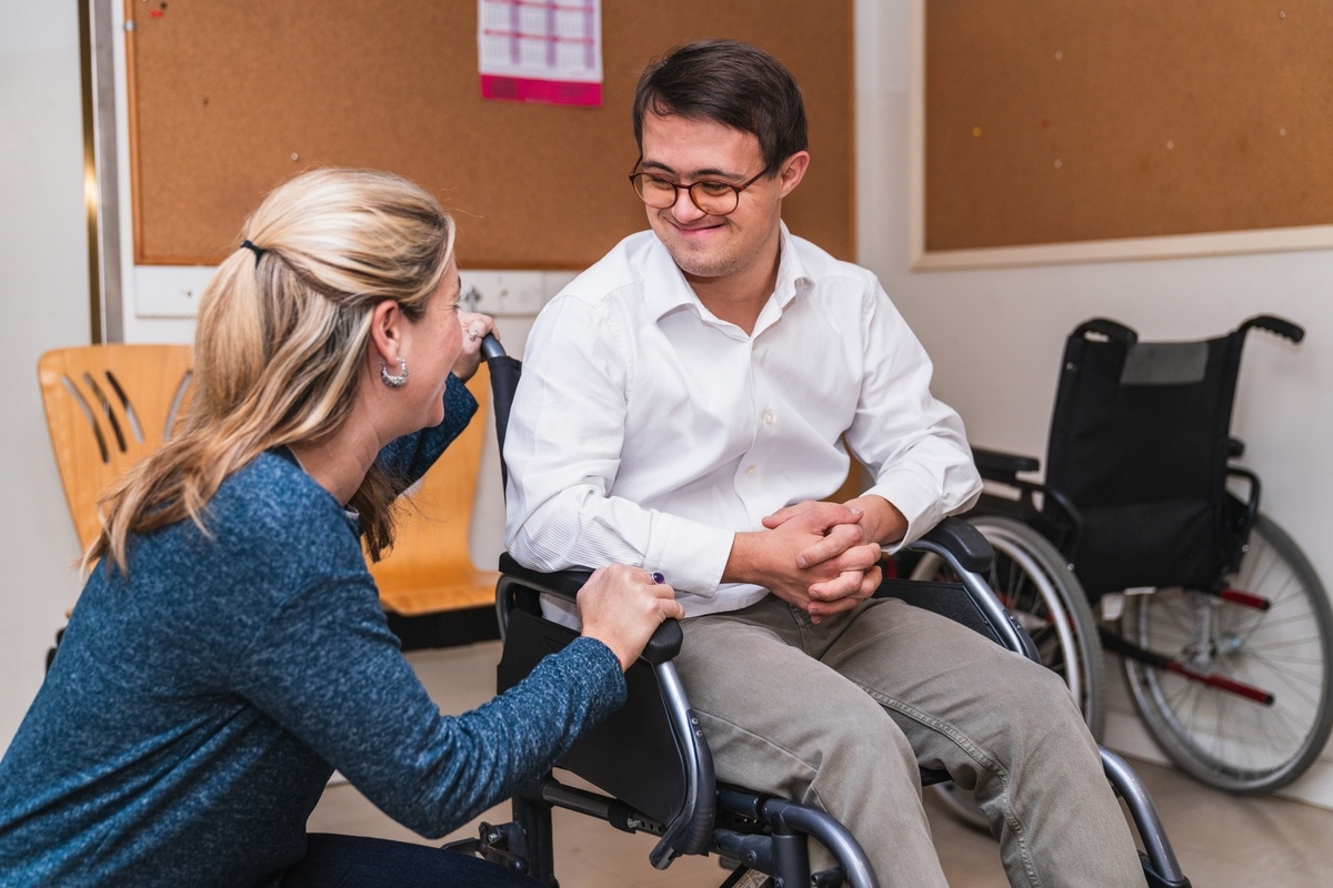 Young man in wheelchair meeting with a care professional for an OPWDD CAS assessment