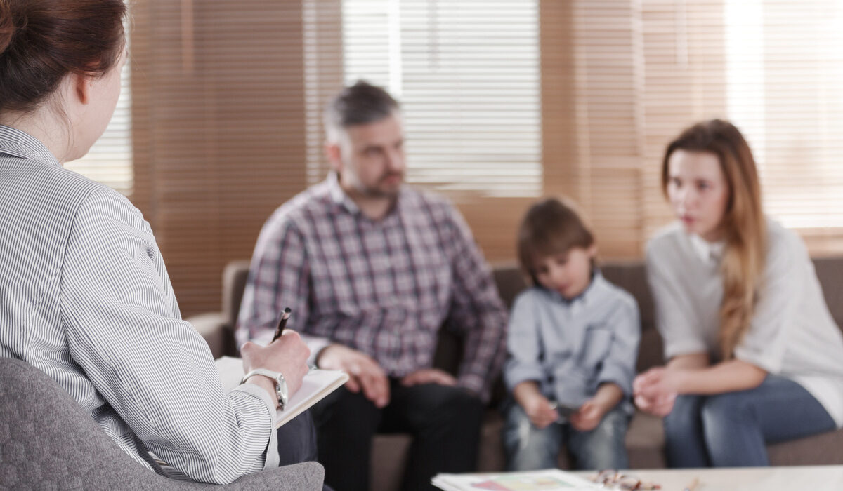 Parents and child meeting with a specialist during a developmental delay vs special needs consultation