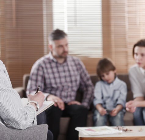 Parents and child meeting with a specialist during a developmental delay vs special needs consultation