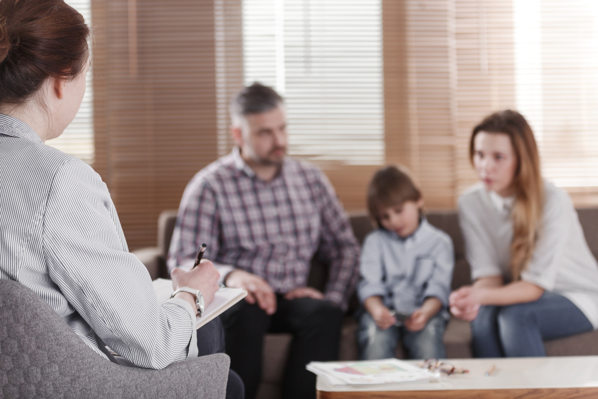 Parents and child meeting with a specialist during a developmental delay vs special needs consultation