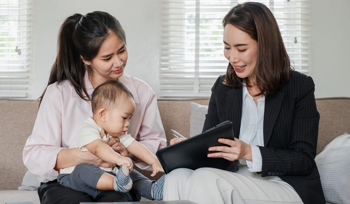 Care manager reviewing an OPWDD life plan with a mother and child during a home planning session