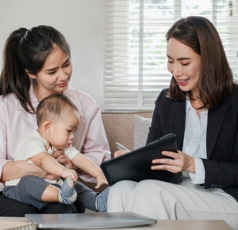 Care manager reviewing an OPWDD life plan with a mother and child during a home planning session