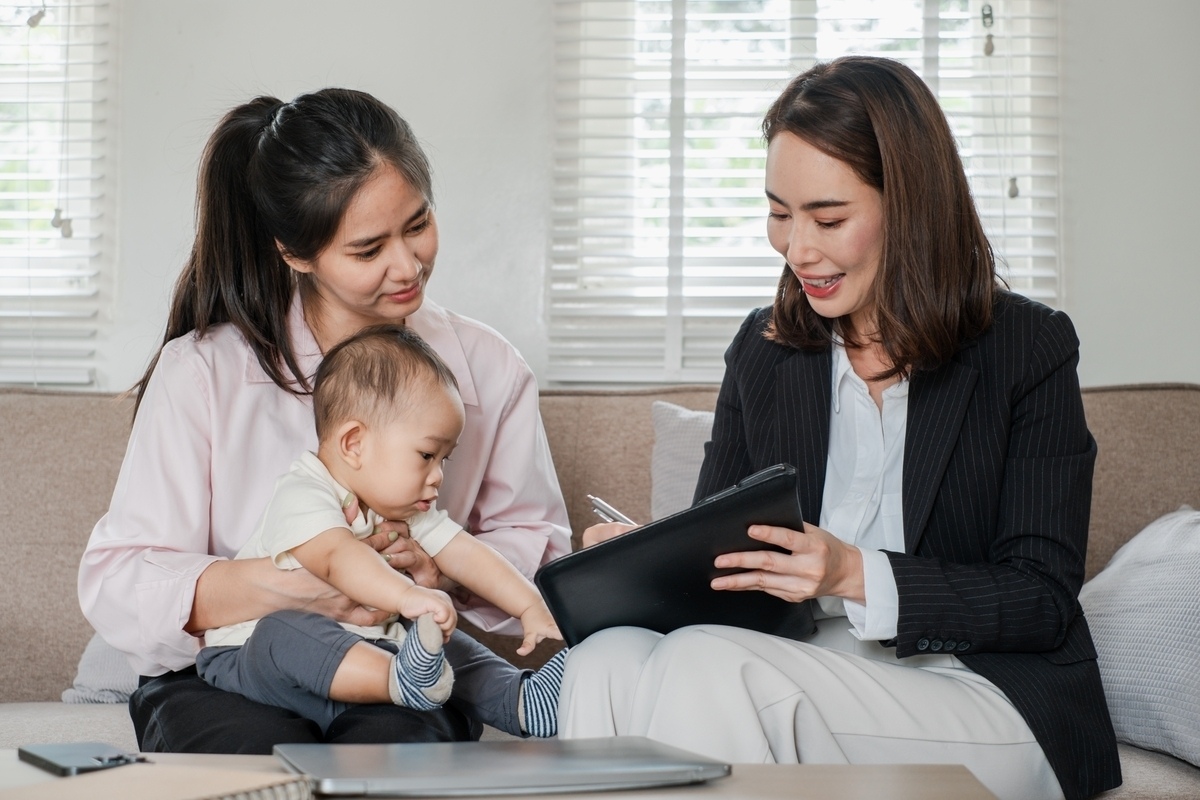 Care manager reviewing an OPWDD life plan with a mother and child during a home planning session