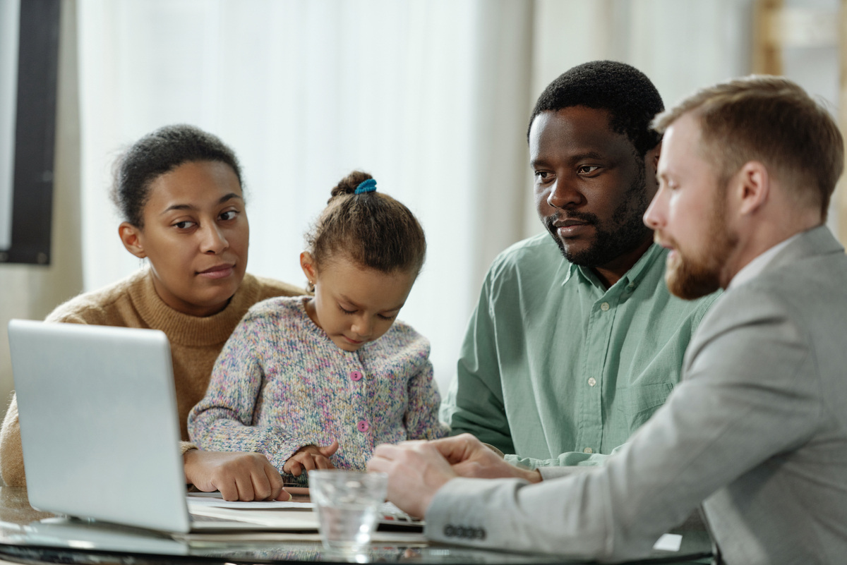 Family with child meeting with a support broker to review the OPWDD Self-Direction Program plan and budget
