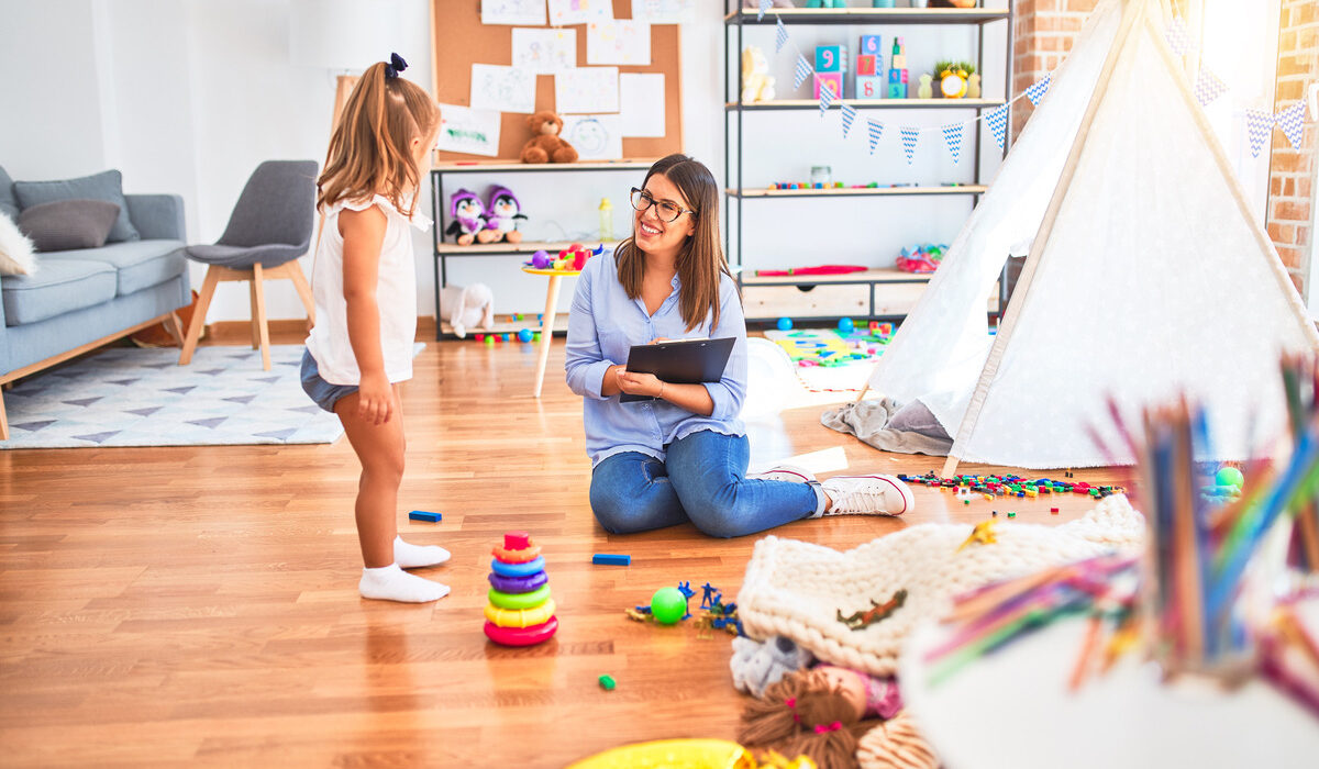 Trained caregiver engaging warmly with a child during an in-home respite care for special needs session