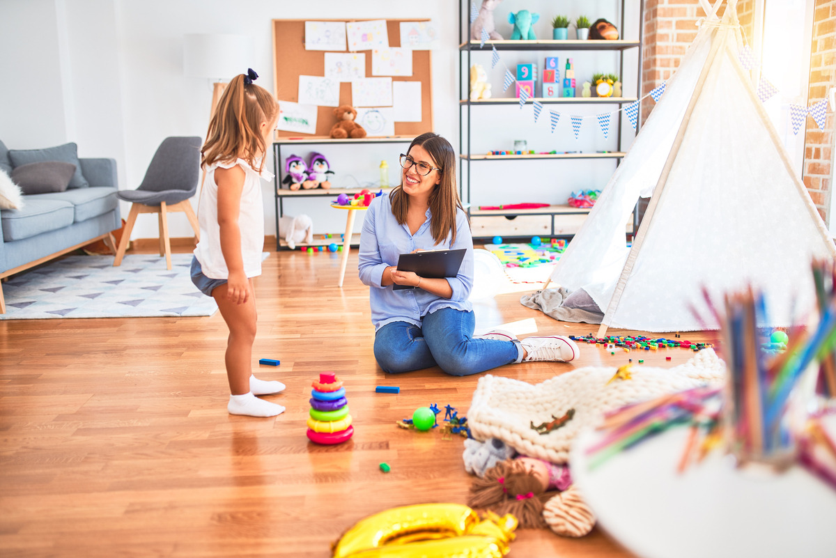Trained caregiver engaging warmly with a child during an in-home respite care for special needs session