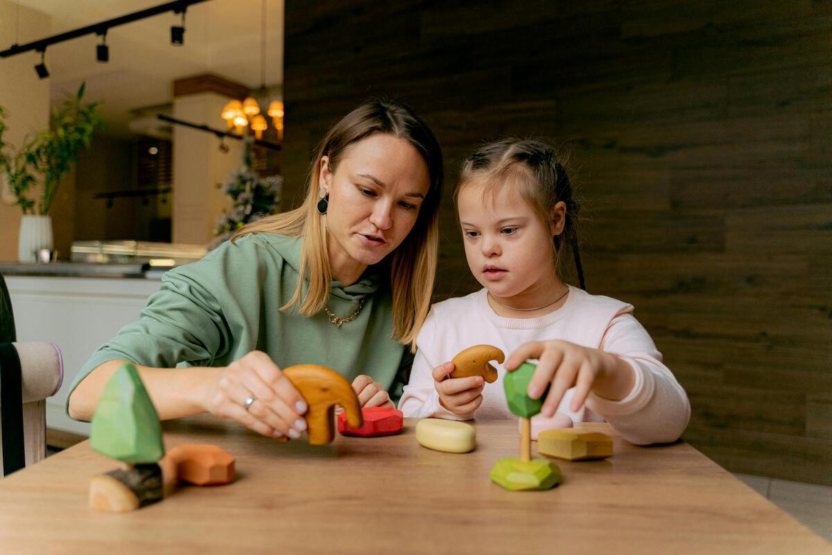 Caregiver working with a child on the OPWDD program in Queens NY during an in-home developmental support session