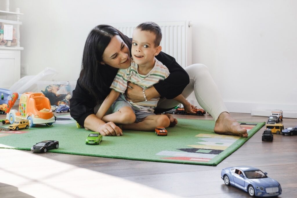 Caregiver providing special needs care in Yonkers NY playing with a child on the floor during an in-home support session