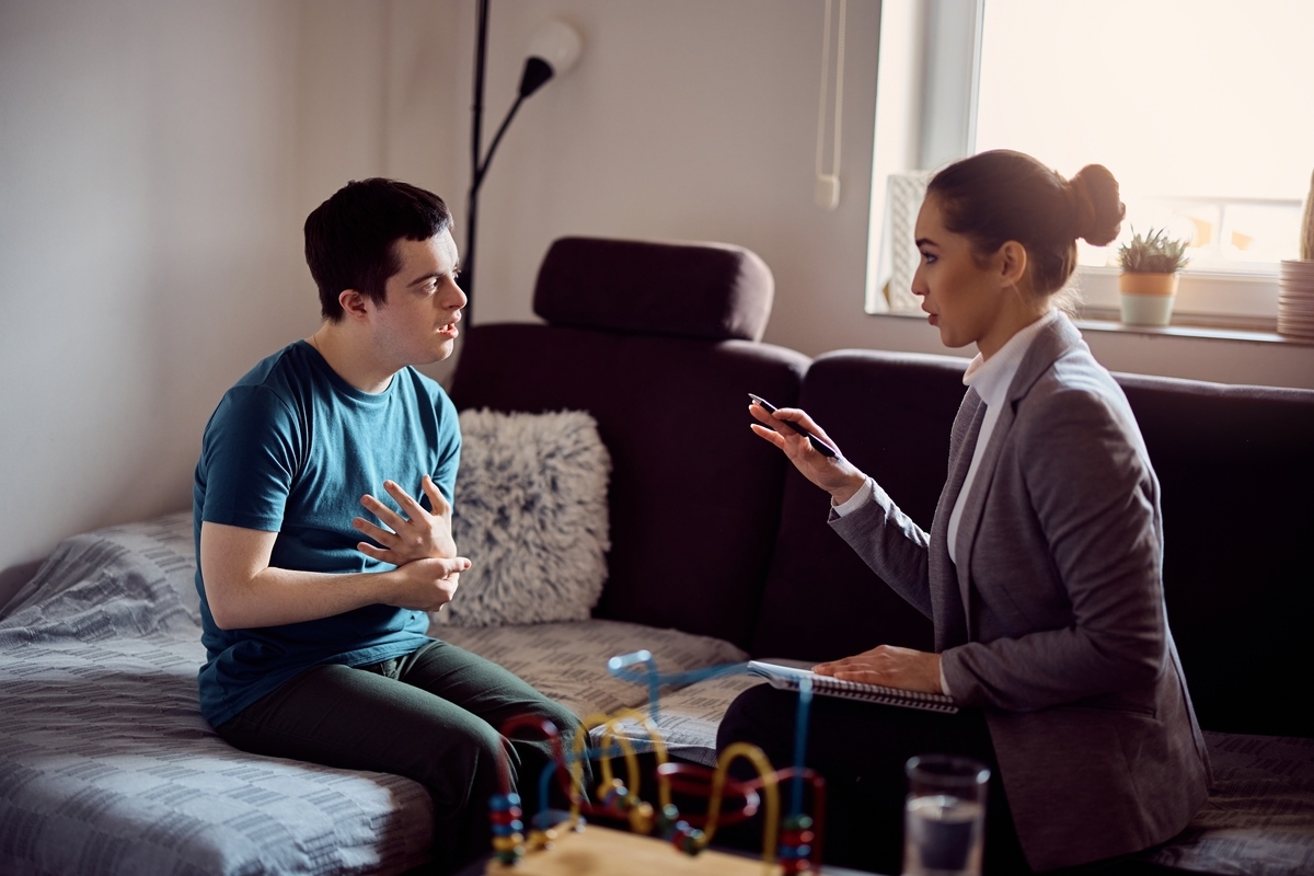 Caregiver discussing a care plan with a client during OPWDD Services in Sunset Park