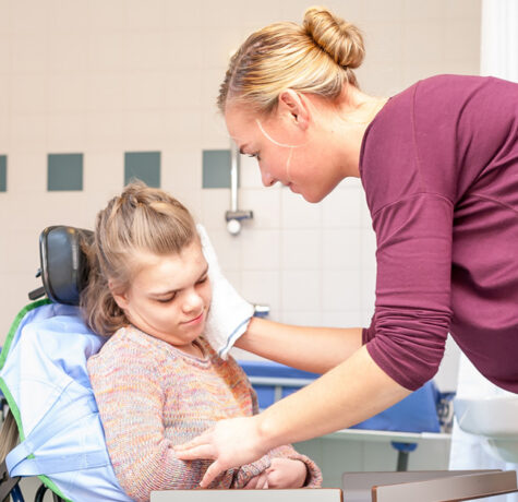 Special Needs Caregiver supporting a child during an everyday activity
