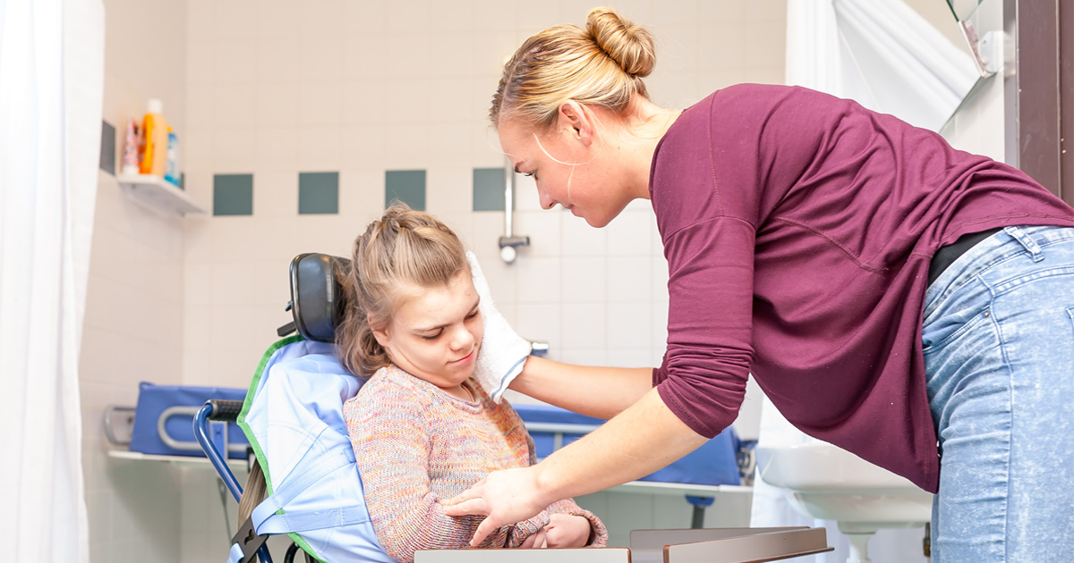Special Needs Caregiver supporting a child during an everyday activity